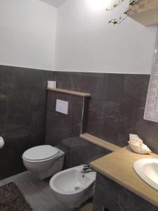 a bathroom with a toilet and a sink at agriturismo heaven in Capo Vaticano