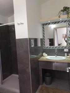 a bathroom with a sink and a shower and a mirror at agriturismo heaven in Capo Vaticano