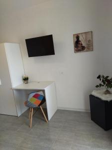 a white desk and a chair in a room at agriturismo heaven in Capo Vaticano