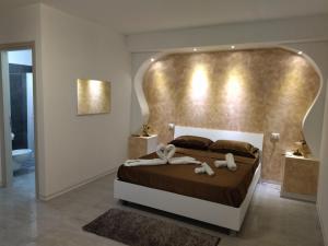 a bedroom with a large bed with a gold headboard at agriturismo heaven in Capo Vaticano