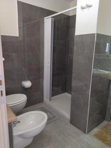 a bathroom with a shower and a toilet and a sink at agriturismo heaven in Capo Vaticano