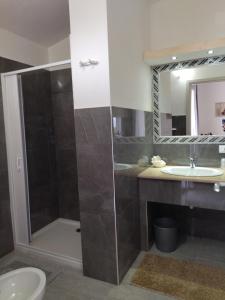 a bathroom with a shower and a sink at agriturismo heaven in Capo Vaticano