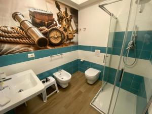 a bathroom with a sink and a toilet and a shower at 103 Boutique Hotel Stintino in Stintino