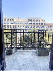 a balcony with two benches and a large building at B&B Mazzini in Rome