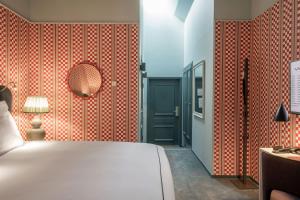 a bedroom with a bed and a red wall at The Sparrow Hotel in Stockholm