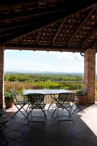 a table and chairs on a patio with a view at B&B di Spineto in Carbonara Scrivia