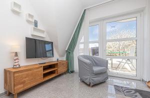 TV a/nebo společenská místnost v ubytování Meer Appartement