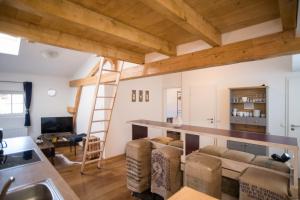 a kitchen and living room with wooden ceilings at Wendelstein Lodge in Fischbachau