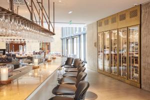 a bar with leather chairs in a restaurant at Scandic Frankfurt Museumsufer in Frankfurt