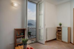 a room with a door open to a balcony at Casa Sole in Varenna