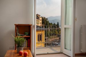 an open door to a balcony with a view of a building at Casa Sole in Varenna