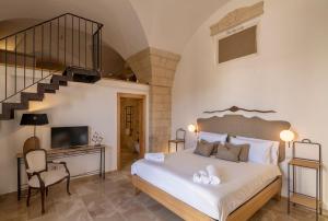 a bedroom with a large bed and a staircase at Dimora Oru in Lecce