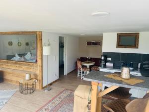 a room with a kitchen and a living room at Wendelstein Lodge in Fischbachau