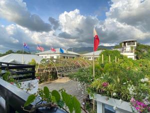 a view of a garden with flags and flowers at Casa Cecilia Hotel in Bantay