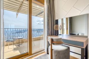 a room with a desk and a view of the ocean at Quercus Residences Apartments in Sveti Stefan +107 photos