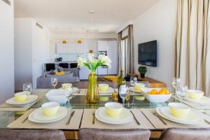 a dining room and living room with a table and chairs at The Haneviim Court - 3BDR High Standard in Jerusalem