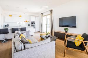 a living room with a couch and a tv at The Haneviim Court - 3BDR High Standard in Jerusalem