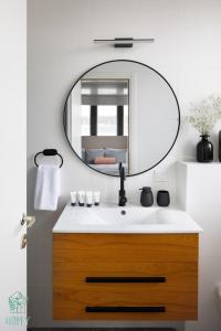 a bathroom with a sink and a mirror at HAYARKON - Superior Collection - By HOMY in Tel Aviv +75 photos