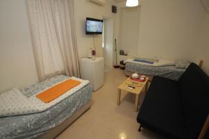 En eller flere senger på et rom på Sukhum City Mini Hotel