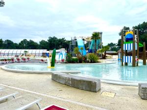 a large water park with a water slide at Spacieux Mobilhome Premium/Camping 5* in Vendays-Montalivet
