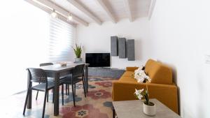 a living room with a table and a couch at Sardinianworld - Xenia Boutique in Oristano