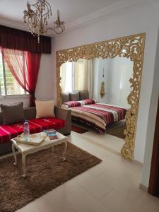 a living room with a large mirror and a couch at Dar La Leila in Tunis