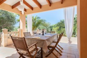 een eetkamer in de openlucht met een tafel en stoelen bij Casa Antonio Invierno in Cala Llombards
