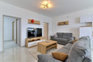 a living room with two couches and a tv at Apartment Luka in Senj
