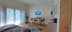 a room with a bed and a desk with a television at Kuninga 24/2 Old Town Apartments in Pärnu