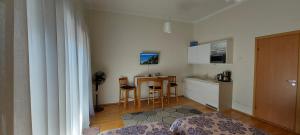 a kitchen with a counter and a table with chairs at Kuninga 24/2 Old Town Apartments in Pärnu
