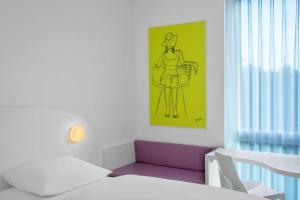 
Ein Bett oder Betten in einem Zimmer der Unterkunft prizeotel Bremen-City
