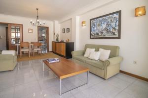 a living room with a couch and a table at Santa Barbara Flat in Arcos de Valdevez