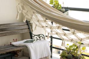 a porch with a bench with a book on it at Santa Barbara Flat in Arcos de Valdevez