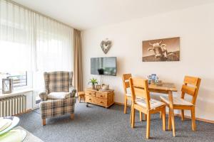 a living room with a table and chairs at Fischener Biberle in Fischen