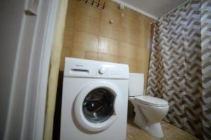 a bathroom with a washing machine and a toilet at Aetos House Exanthia Village in Exanthia