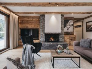 a living room with a couch and a fireplace at VAYA St Anton in Sankt Anton am Arlberg
