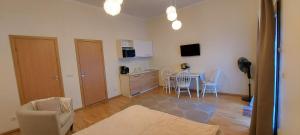 a living room with a kitchen and a table and chairs at Kuninga 24/2 Old Town Apartments in Pärnu