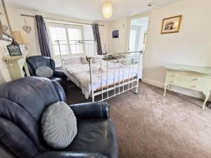 a bedroom with a bed, chair, and desk at The Darlington in Camelford