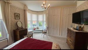 a bedroom with a bed and a living room at Cheriton Lodge in Burnham on Sea