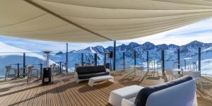 a living room with a view of mountains at Pic Maià Mountain Hotel in Pas de la Casa