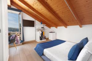 a bedroom with a bed and a large window at Eterea Charming Suites in Sorrento