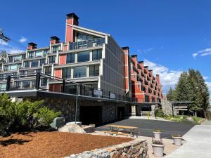 a large building with a bench in front of it at Summer Fun - SLOPESIDE 4BR 3BA with 3 Spas, Pool and Sauna - Perfect for Family and Friend Getaways All Year Round 1849 Condos 693 condo in Mammoth Lakes +56 photos