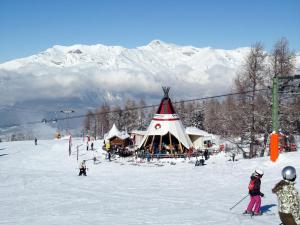 a group of people on a ski slope with a ski lift at Apartment Zinal 301 by Interhome in Les Collons