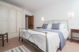 a bedroom with a large white bed with blue pillows at Casa Ijana in Novigrad Istria
