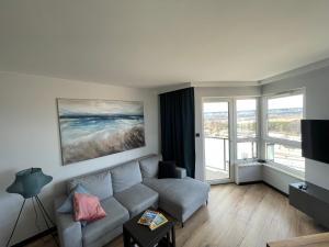 un soggiorno con divano e una grande finestra di Apartament Comfort 10 a Danzica
