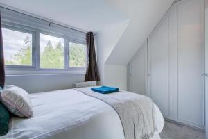 Un dormitorio blanco con una cama y una ventana. en Luxury 3 Bedroom Apartment Close to Beach, Bournemouth & Meyrick Park, en Bournemouth