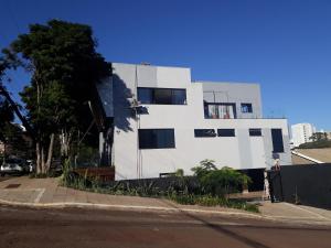 a white building on the side of a street at STUDIO CENTRAL IV in Cascavel