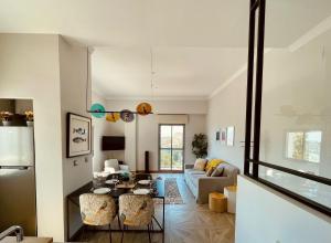 a living room with a table and a couch at Skyline - Penthouse with 50m2 private terrace and stunning views in Cádiz