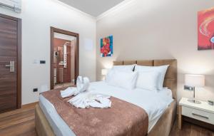 a bedroom with a bed with a towel on it at Hotel Dua Residence in Poreč