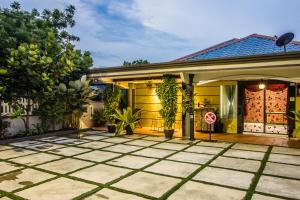 a house with a yellow door and a patio at Surprised Homestay Butterworth in Butterworth